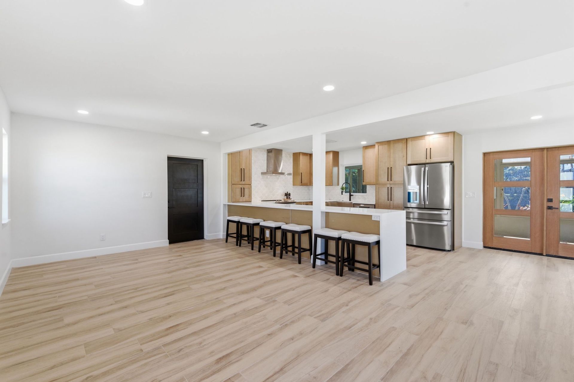 Hand drawing architectural plans with a black pen, close-up on white paper.