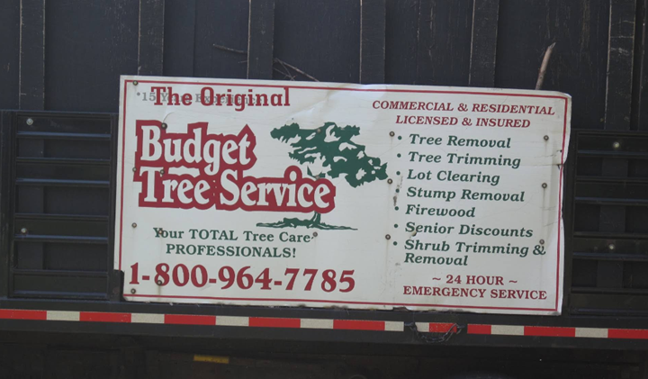 A sign for the original budget tree service