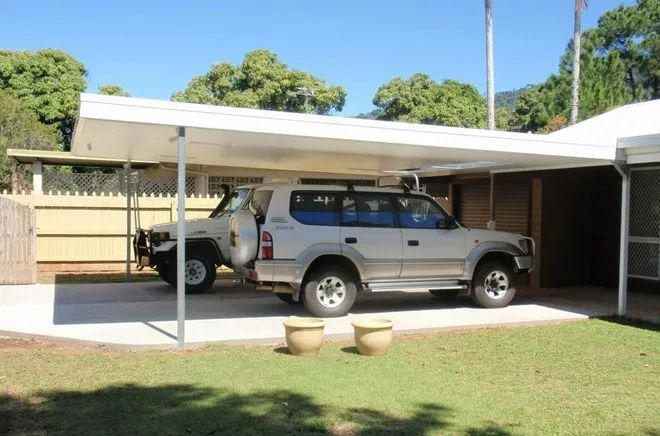 Two Cars Are Parked Under A Canopy In Front Of A House — Justmill Carpentry & Building in Smithfield, QLD