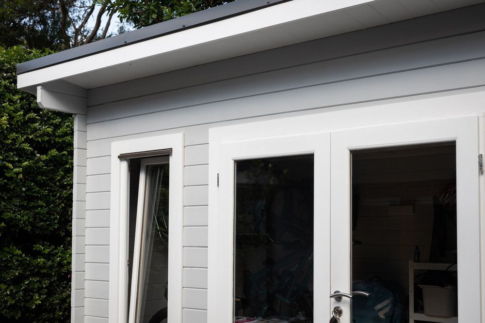 A White House With A Lot Of Windows And Doors — Justmill Carpentry & Building in Smithfield, QLD