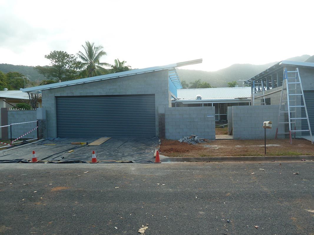 A House That Is Being Built With A Garage And A Ladder In Front Of It — Justmill Carpentry & Building in Cairns, QLD