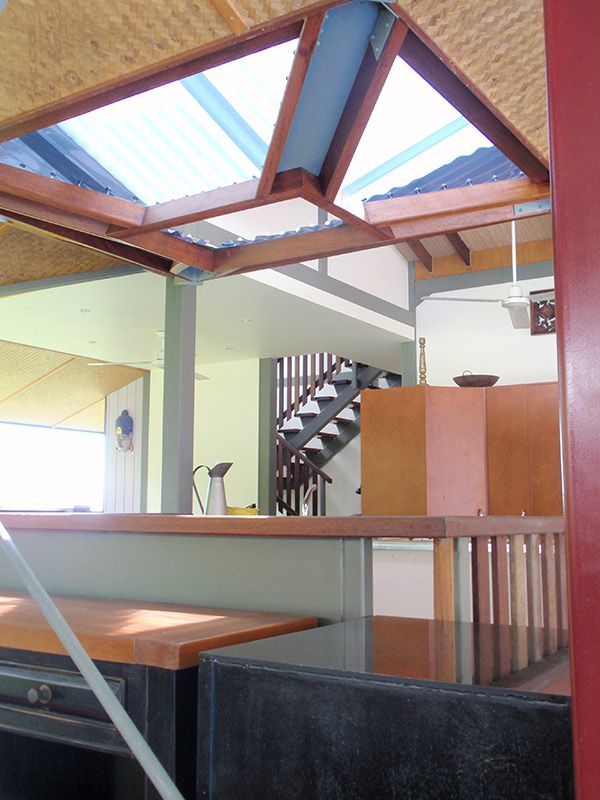 A Kitchen With A Staircase And A Wooden Ceiling — Justmill Carpentry & Building in Northern Beaches, NSW