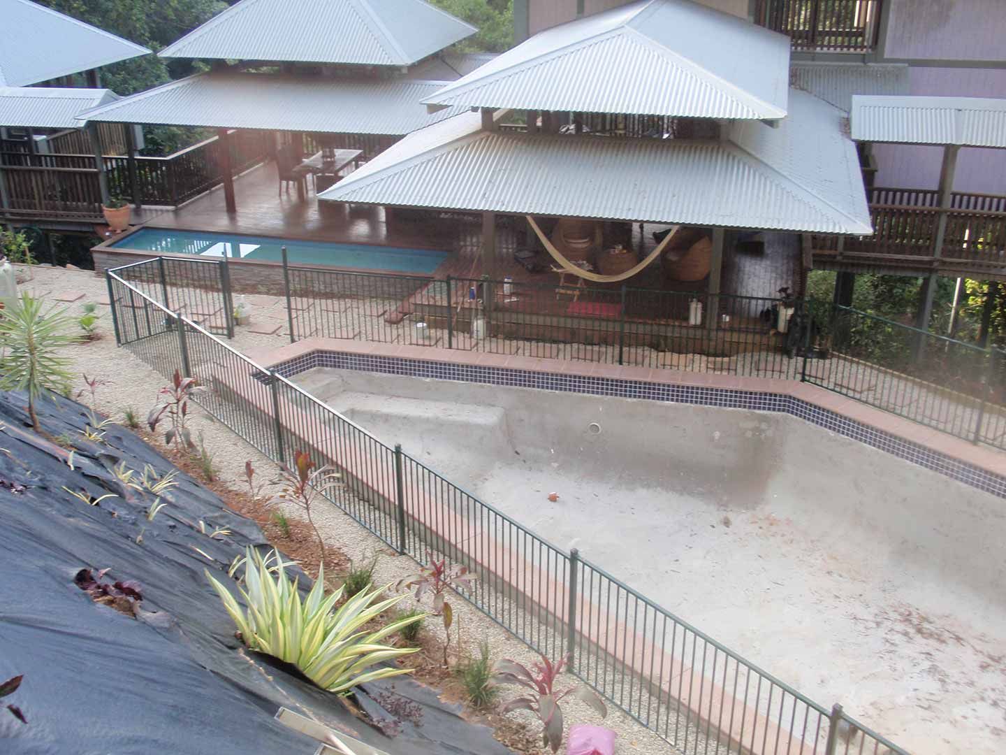 A Large House With A Swimming Pool In Front Of It — Justmill Carpentry & Building in Smithfield, QLD