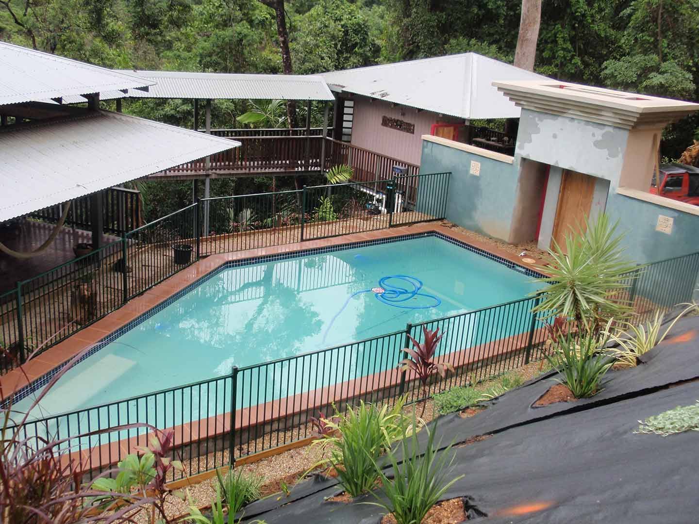 An Aerial View Of A Large Swimming Pool Surrounded By A Fence — Justmill Carpentry & Building in Smithfield, QLD