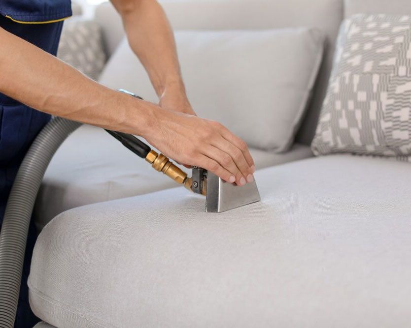 Expertly Vacuuming a White Sofa for a Pristine Clean by Jacsimpson Cleaning Services - Experienced Cleaner in Ballina