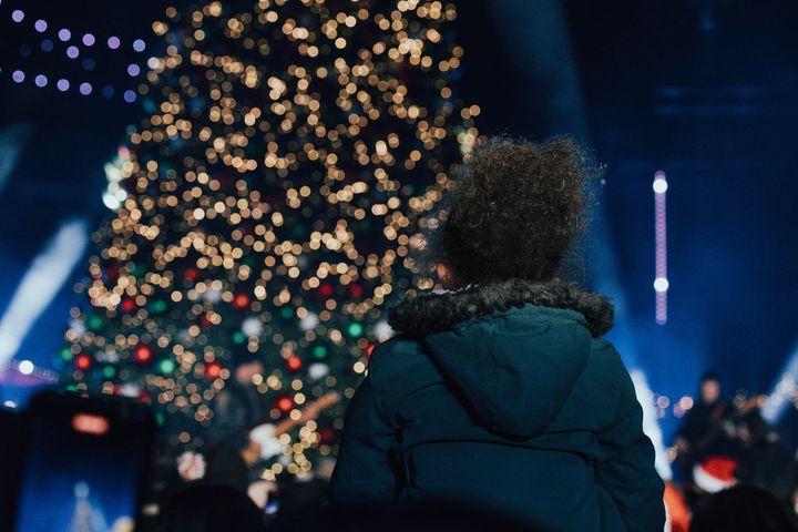 A sign that says cullman christkindlmarkt with fireworks behind it.