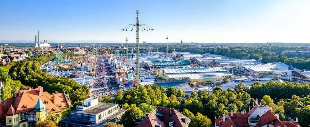 An aerial view of a city with a ferris wheel in the middle of it.