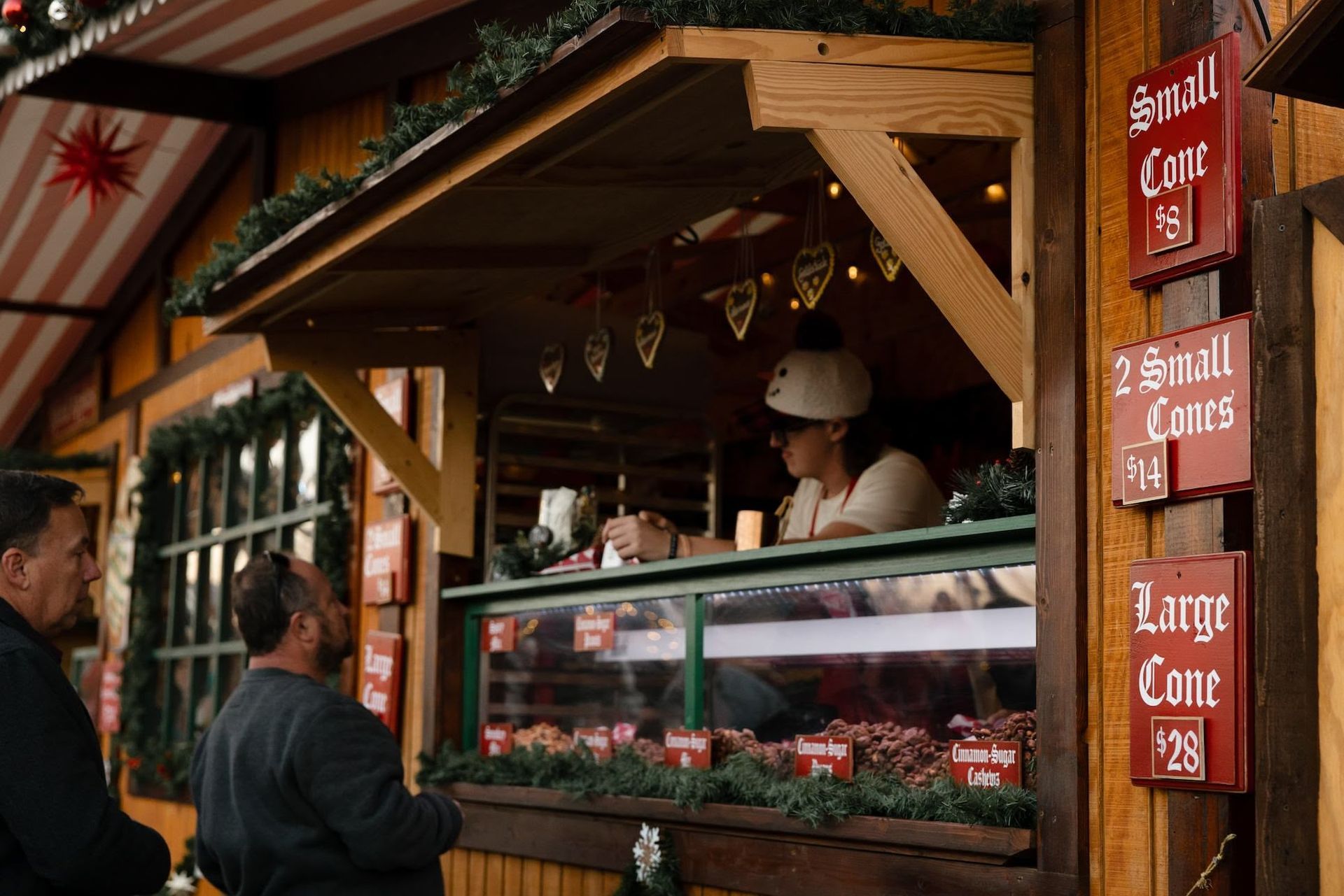 An aerial view of a christmas market with a large christmas tree in the middle.