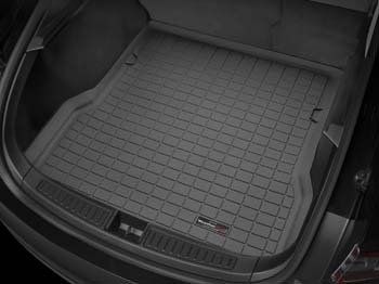 A close up of the trunk of a tesla model s with a trunk mat.