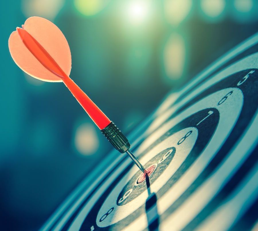 A dart is hitting the center of a target.