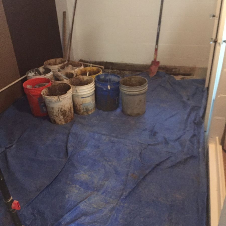 Buckets and a tarp during waterproofing and foundation repair service