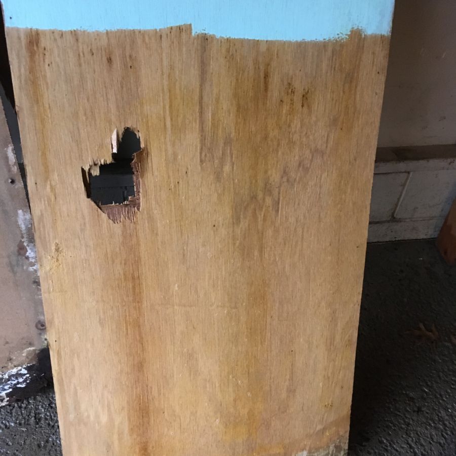 Wooden board with hole in it found by our French drain contractor