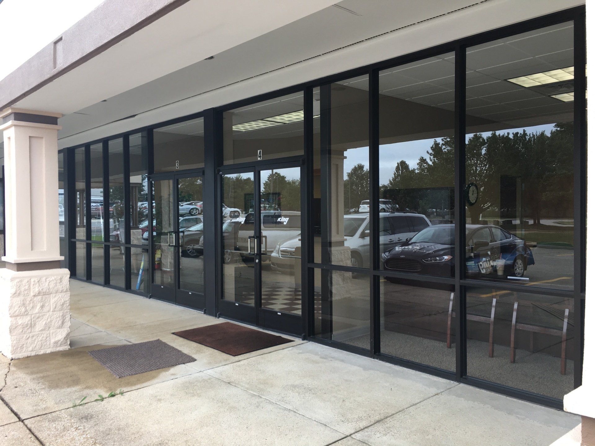 A building with a lot of windows and cars parked in front of it