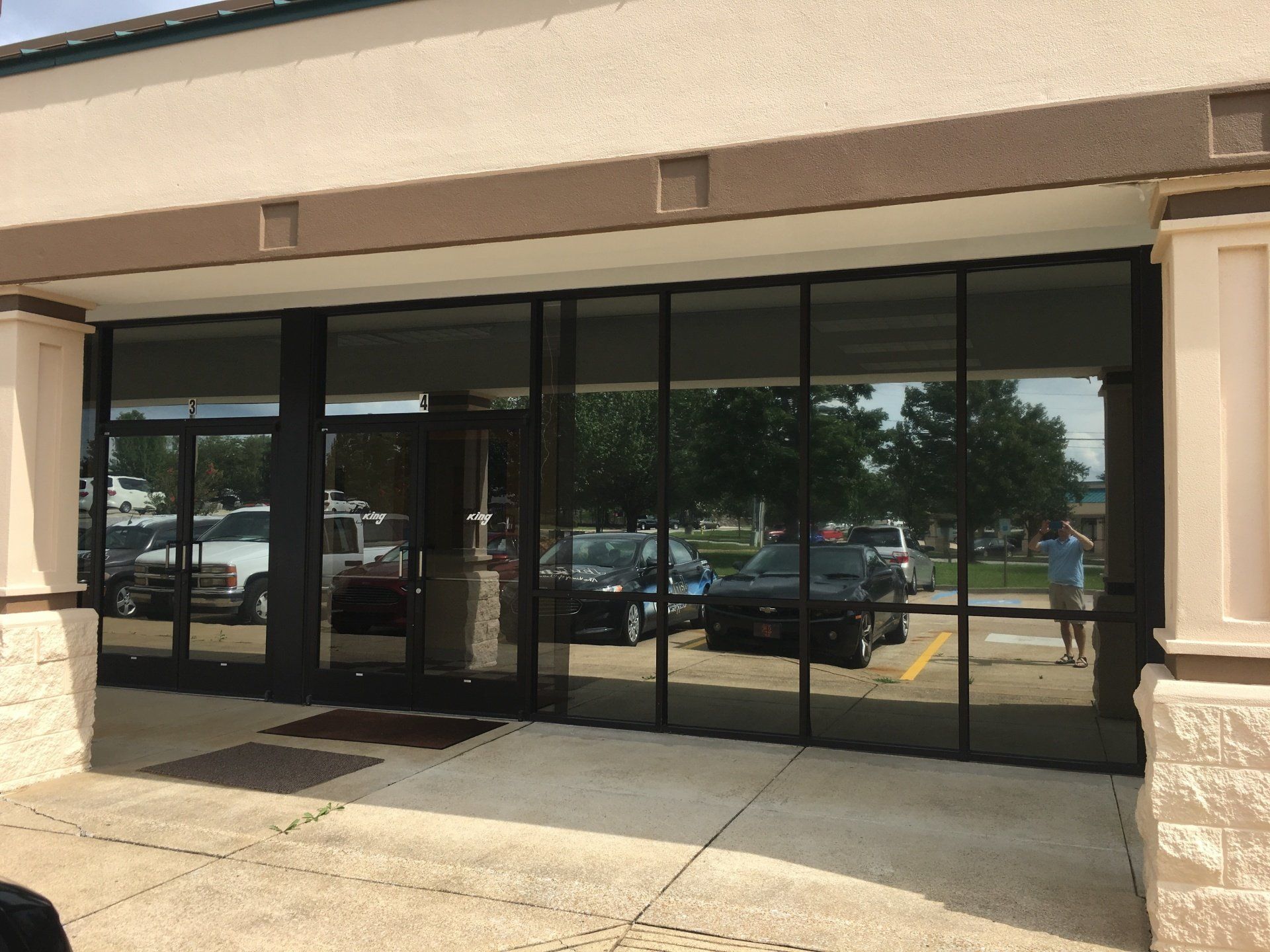 A building with a lot of windows and cars parked in front of it