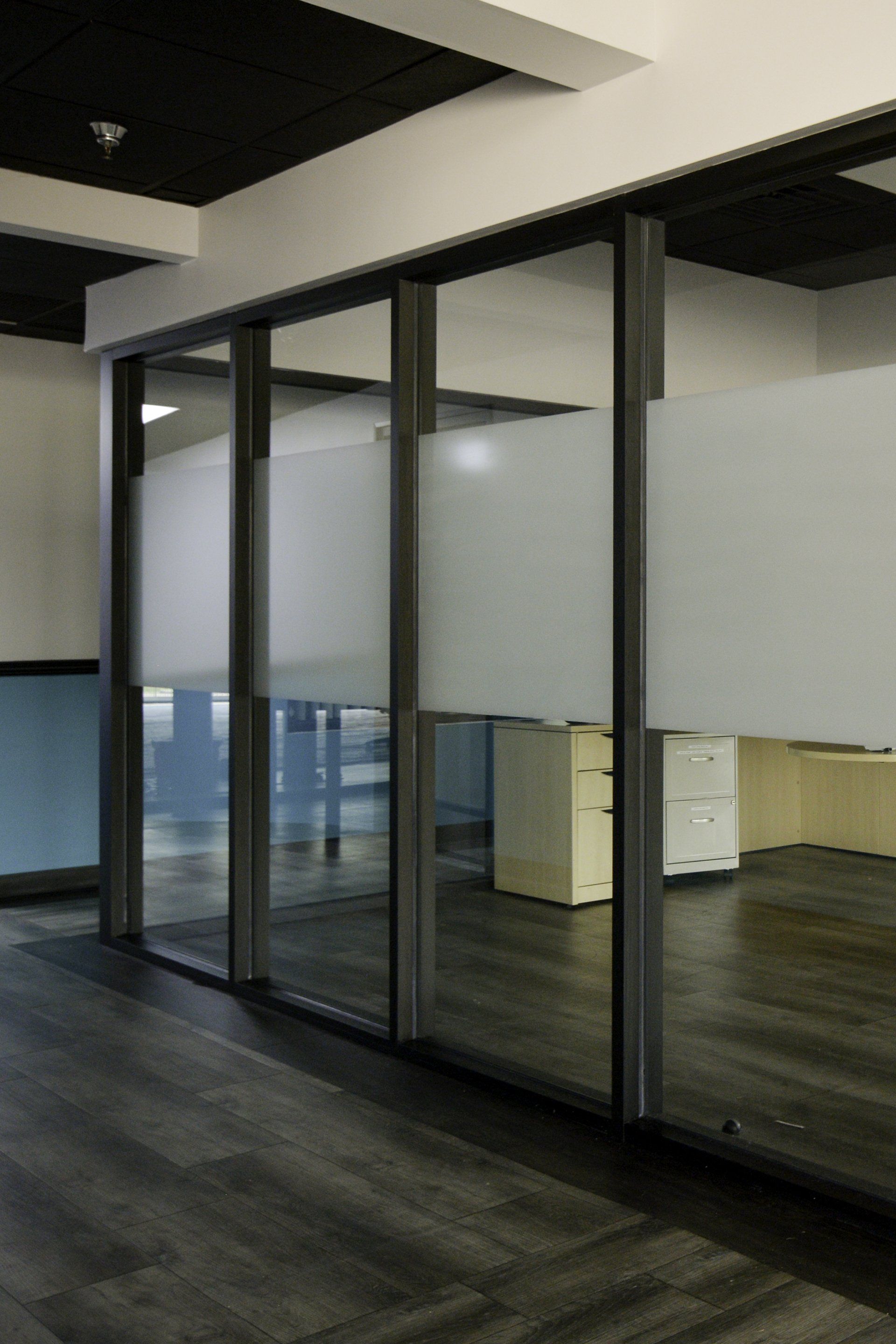 A room with a lot of windows and a wooden floor