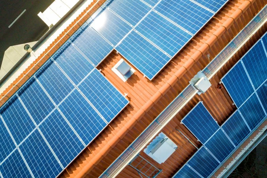 An Aerial View of a Building With Solar Panels on the Roof — Innovo Electrical & Solar In Thebarton, SA