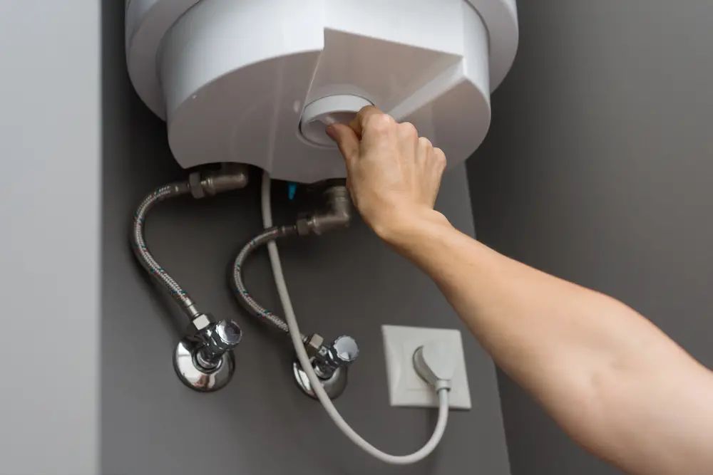 woman checking leaking water heater