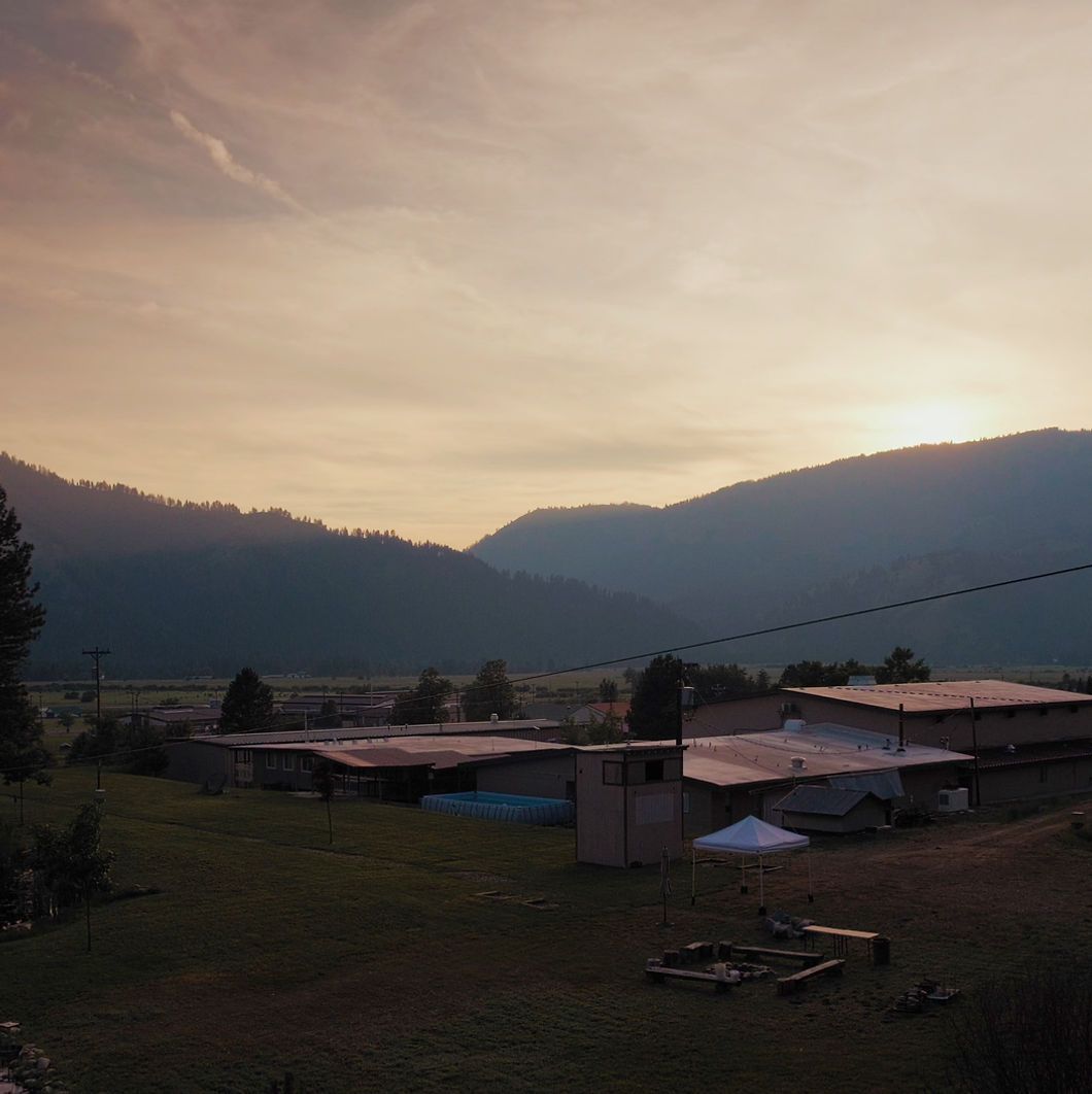 Sunset over a rural landscape with mountains.