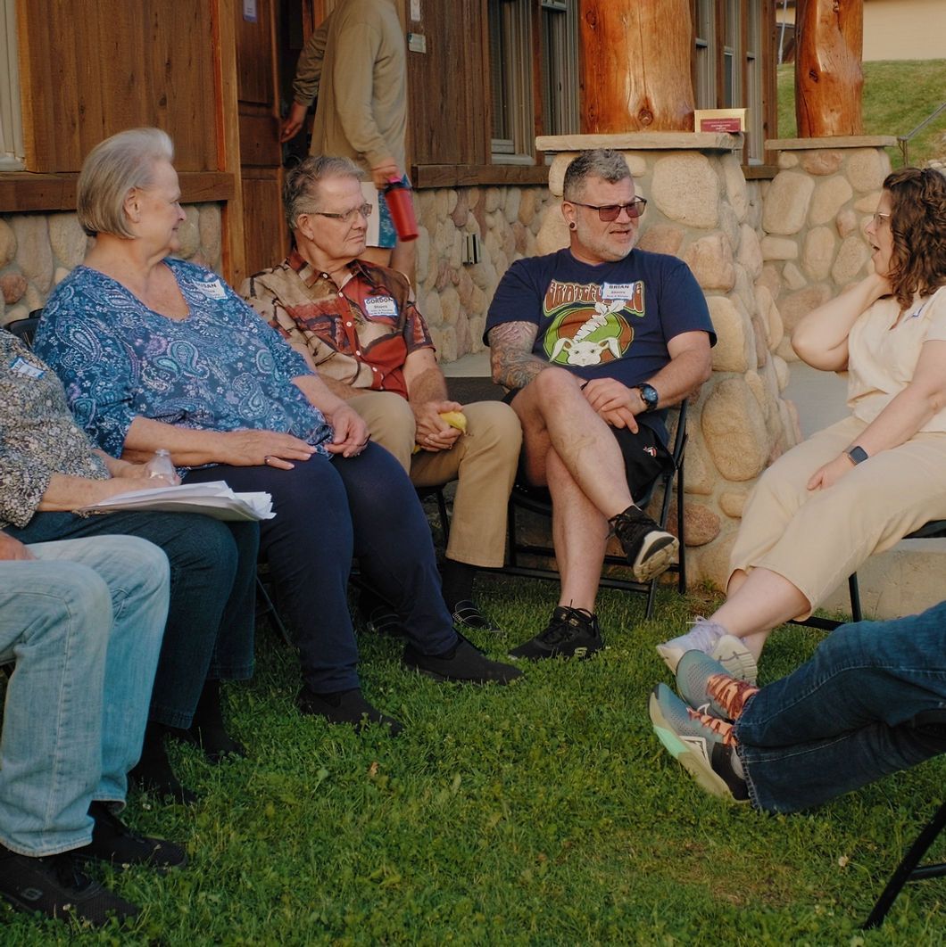 Group of people sitting outdoors.