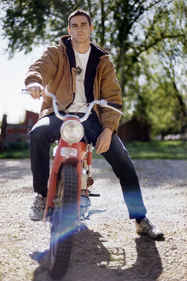Woman with two children, smiling and embracing, on a couch.