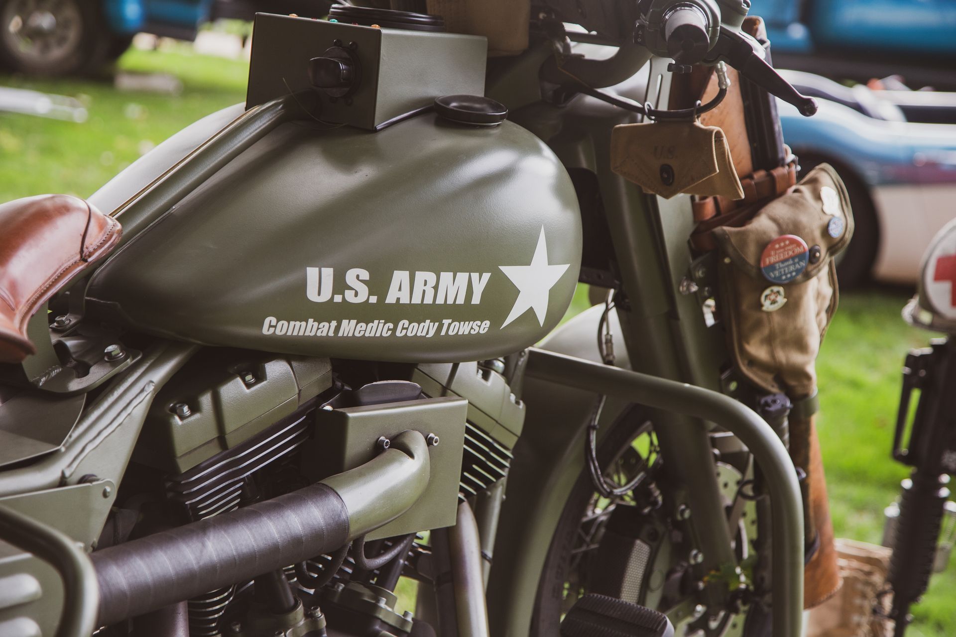 A close-up of a military-style olive green motorcycle with 