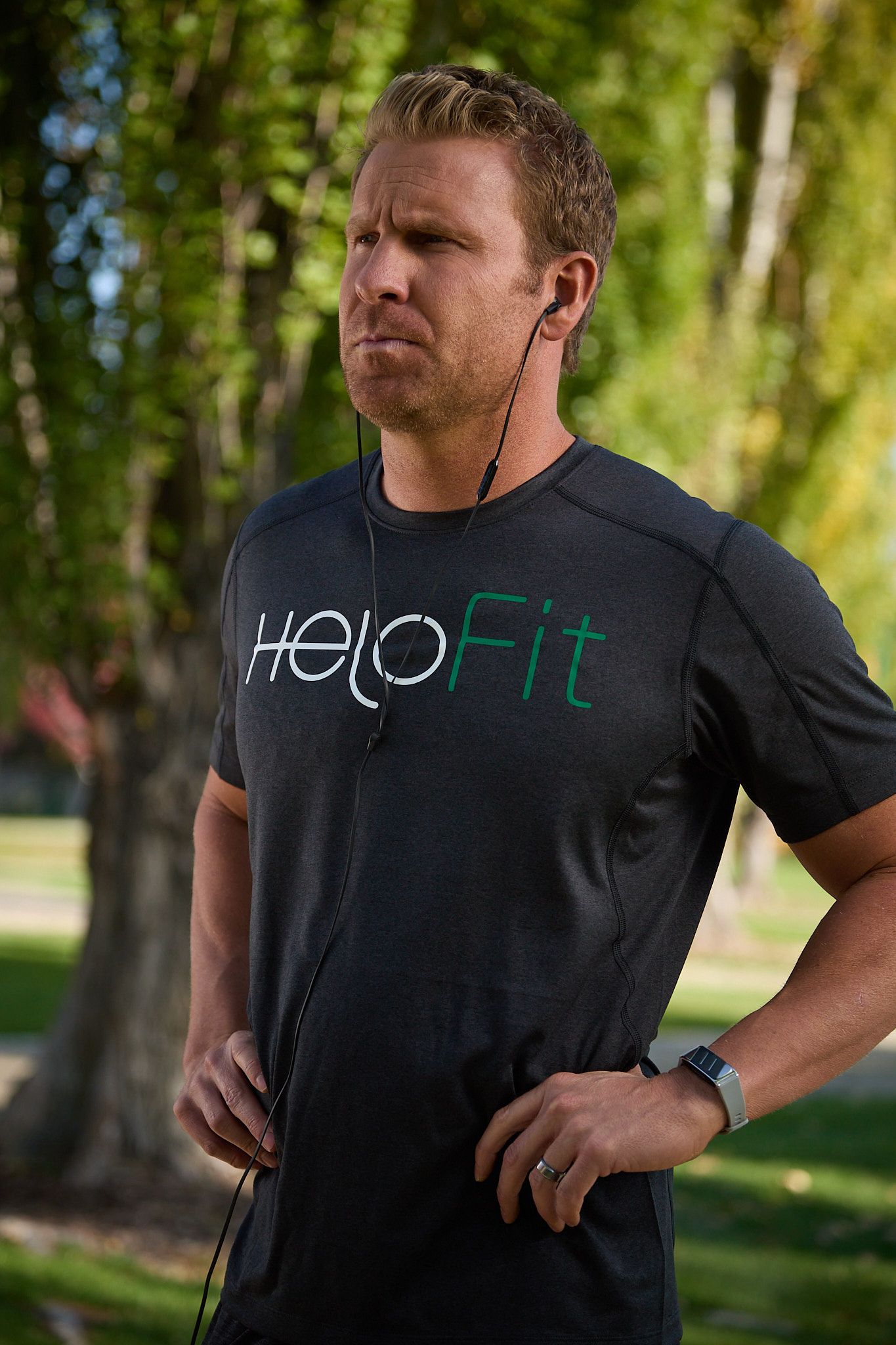 A person with short hair wears a dark gray 