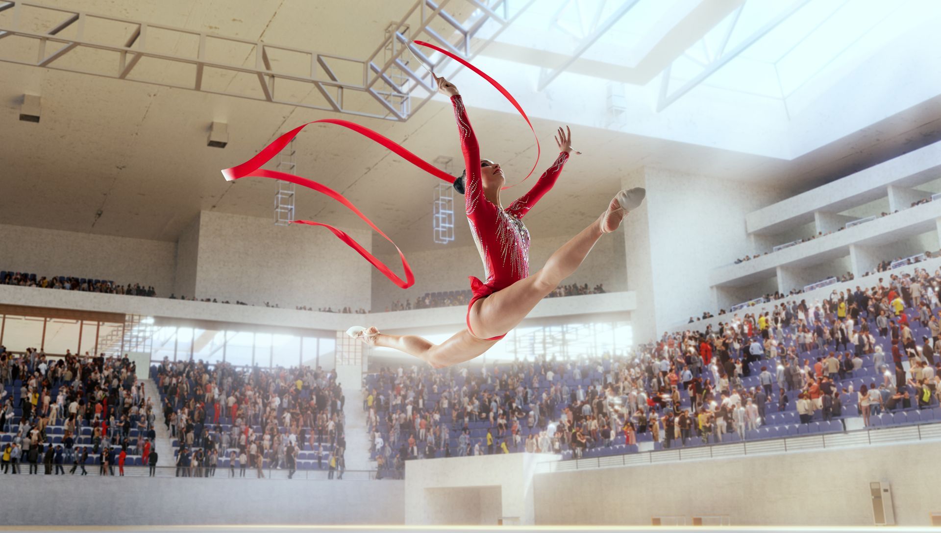 Gymnast in red leotard leaps with red ribbon.
