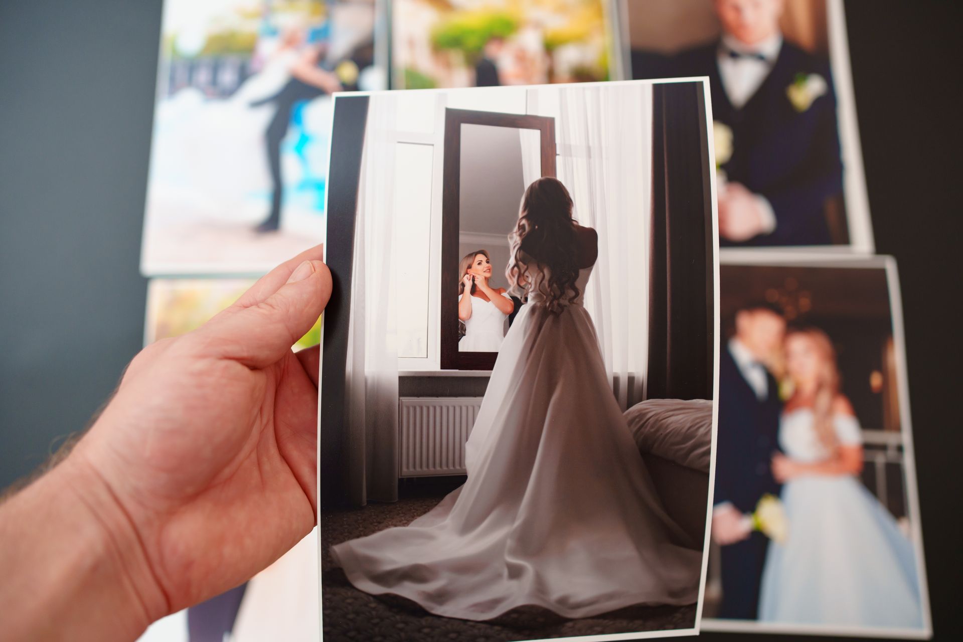 Hand holding a wedding photo.