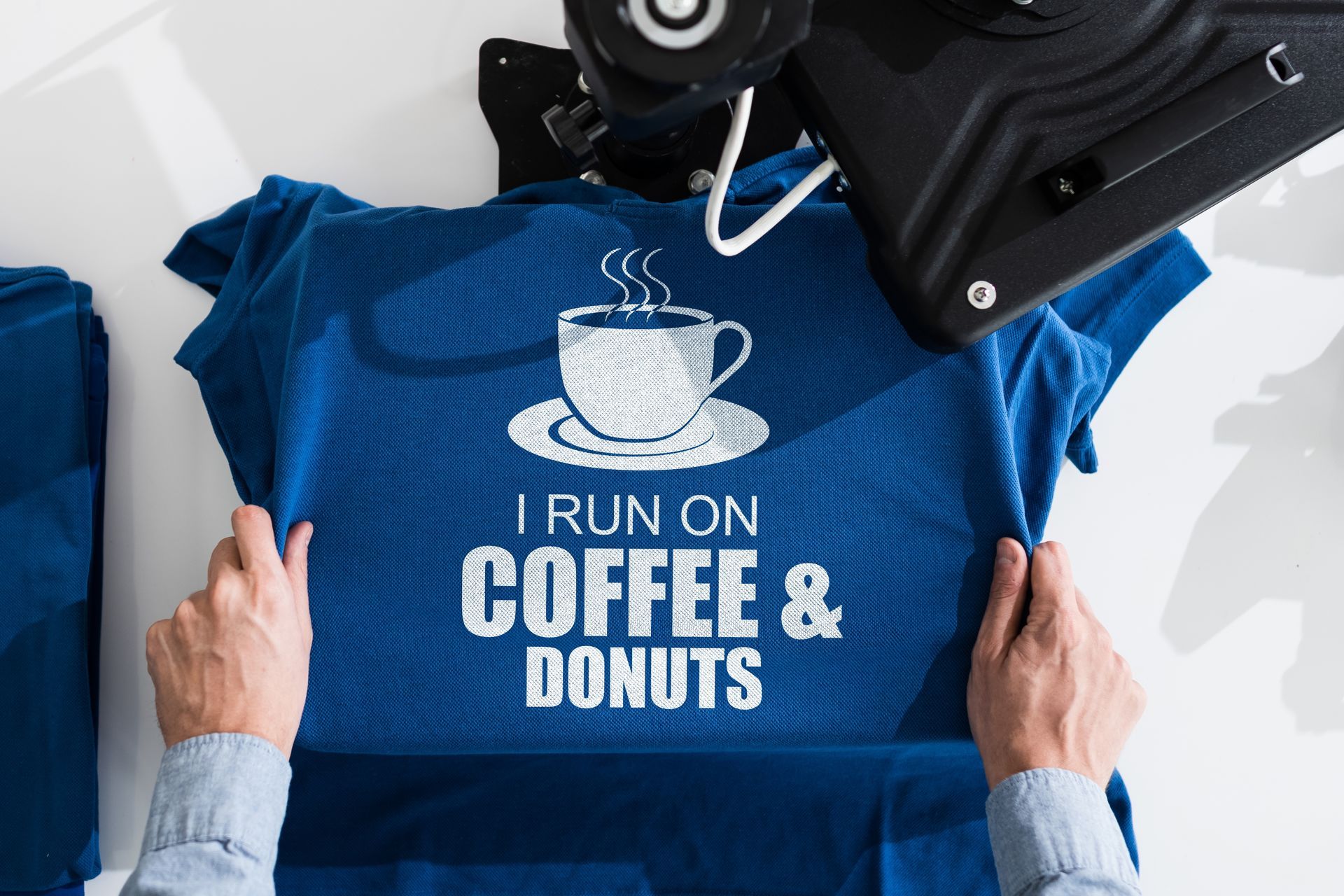 Person holding a blue shirt.