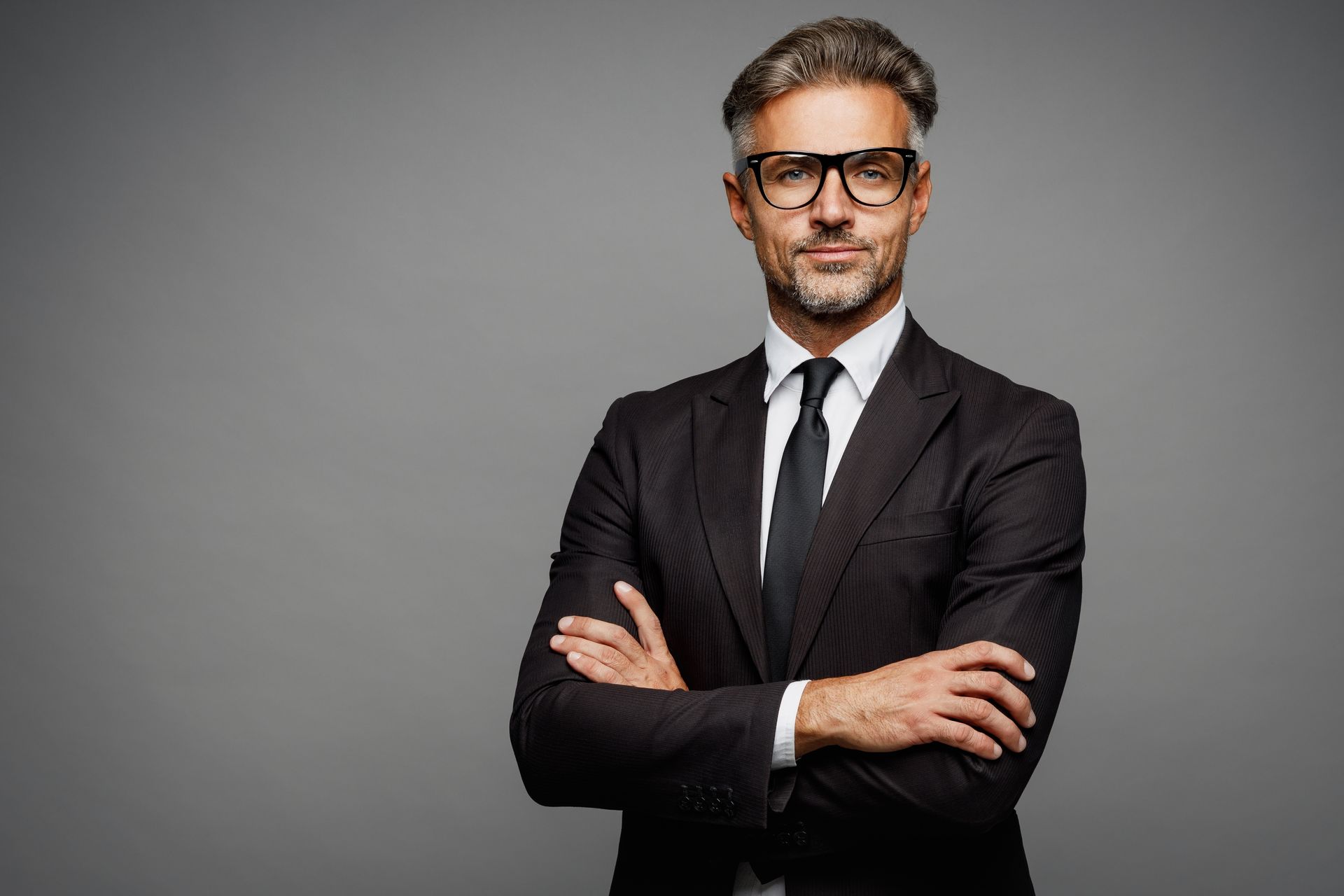 Man in suit with arms crossed.