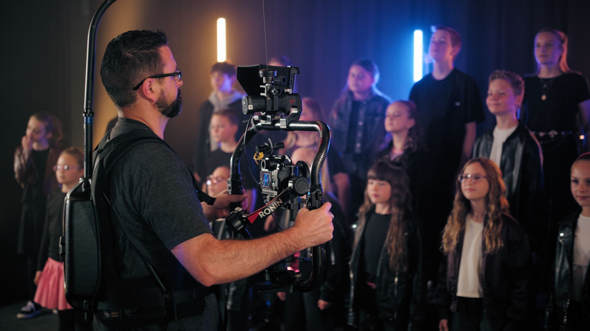 Film crew filming a woman with shocked expression.