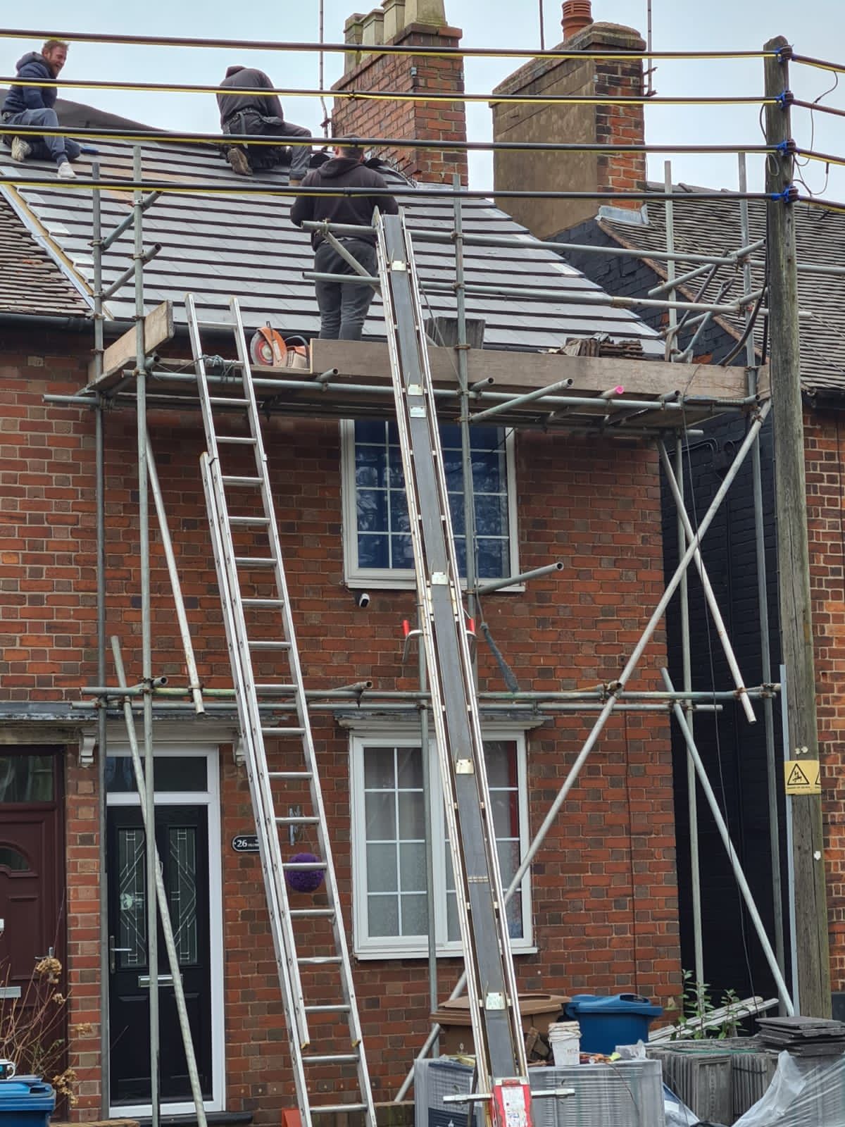 sole trader working on a house clad in scaffolding