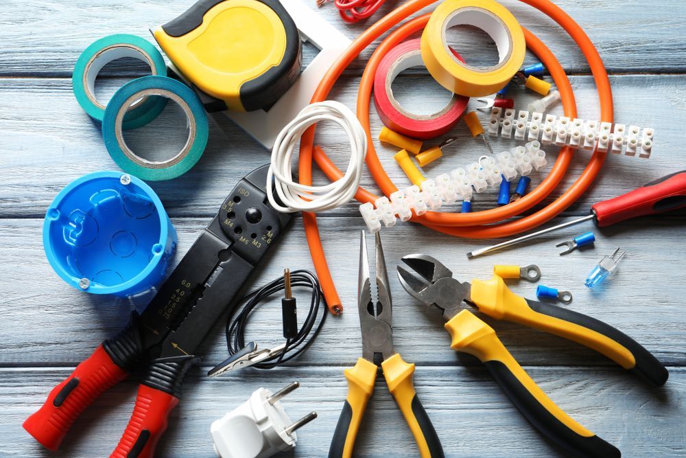 A Bunch of Electrical Tools Are Sitting on A Wooden Table — All Star Electrical Services in Shellharbour, NSW