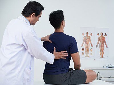 Chiropractor — Chiropractor Examining His Patient in Arcadia, CA