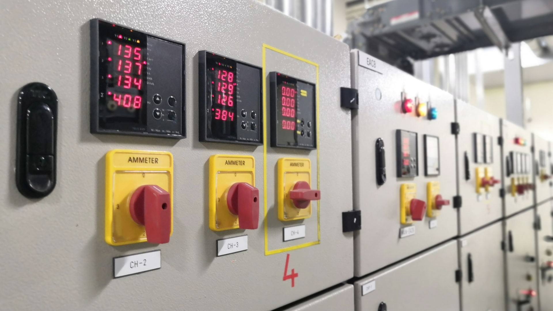 A row of electrical switches and controls on a wall.