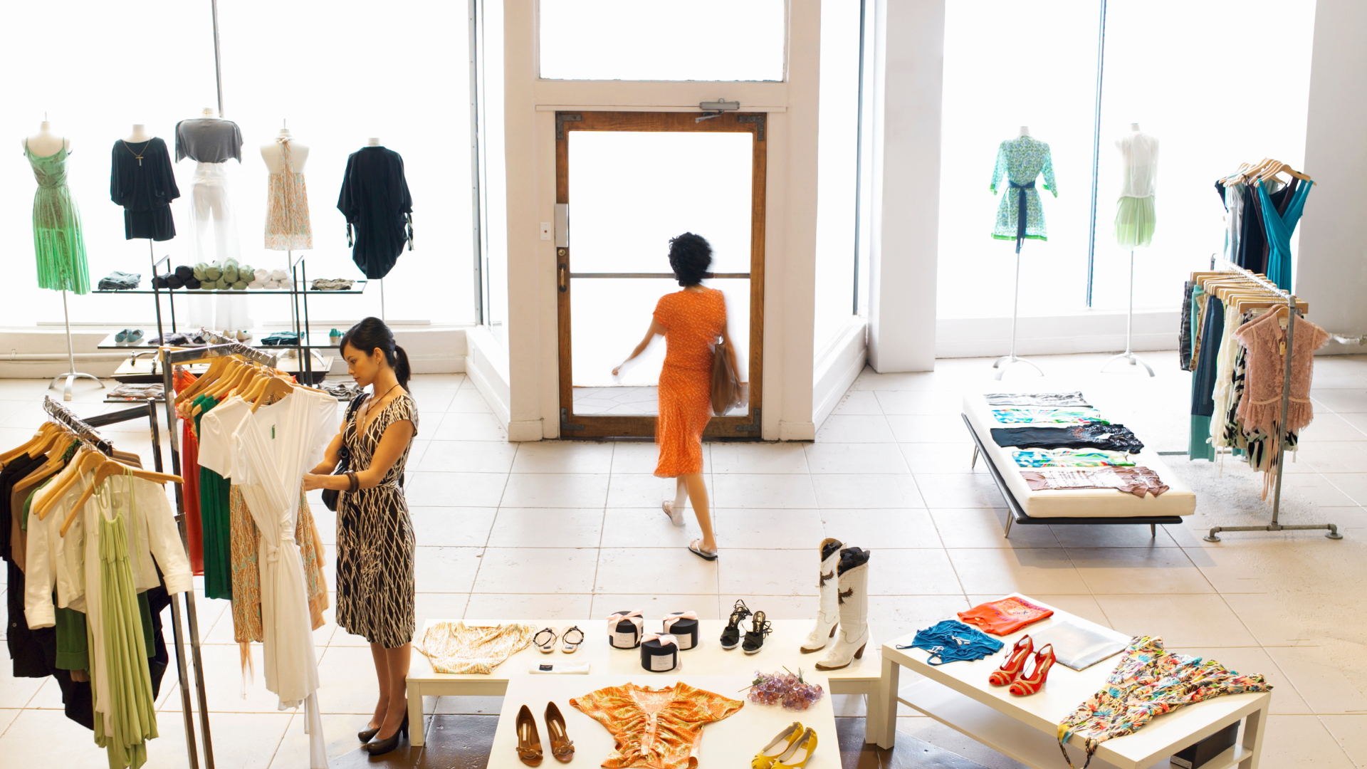 Two women are shopping in a clothing store.