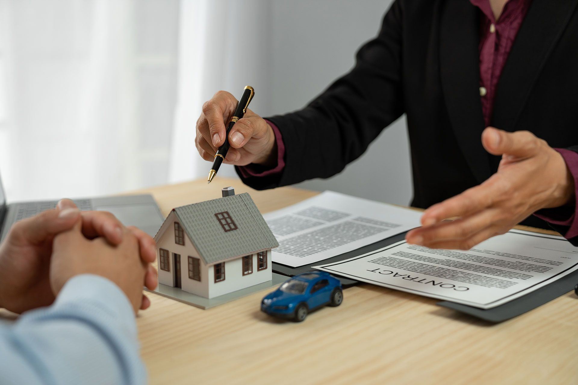 Dealers, home and auto insurance agents are introducing homes to new owners after agreeing to a home sale contract. Renting and Buying a Home real estate agent explaining to client.