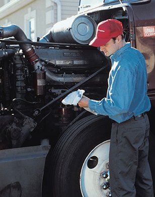 Truck Services — Man Servicing Engine Of Truck in Swannanoa, NC