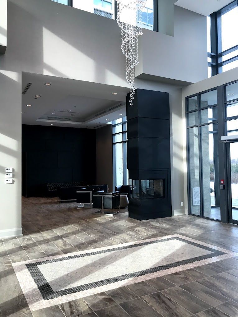 A large room with a fireplace and a chandelier hanging from the ceiling.