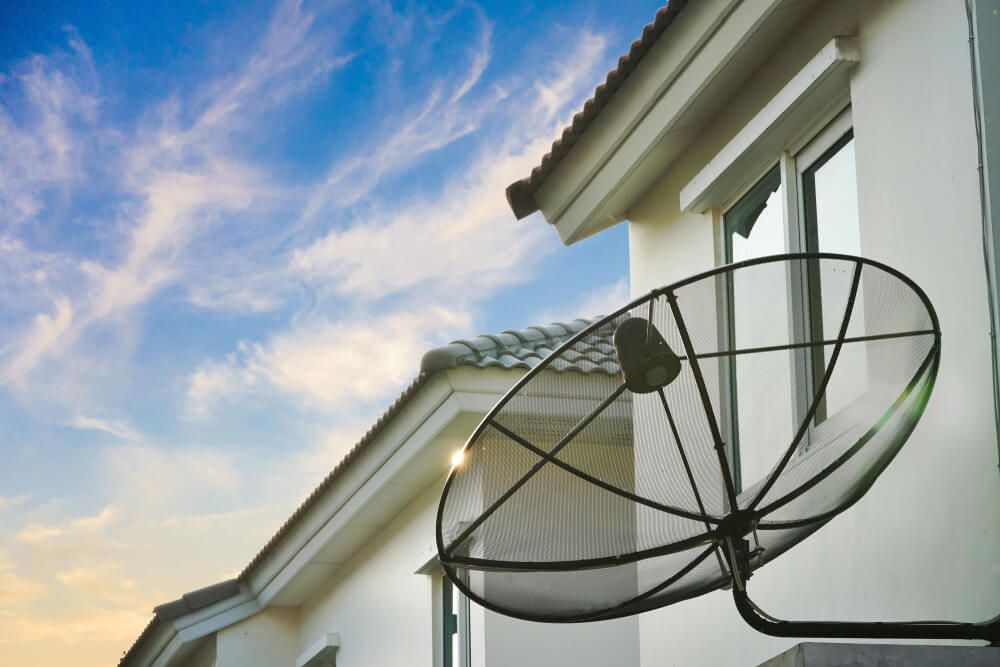A Satellite Dish Is Attached to The Side of A House — BTV Antenna & Data in Coral Cove, QLD
