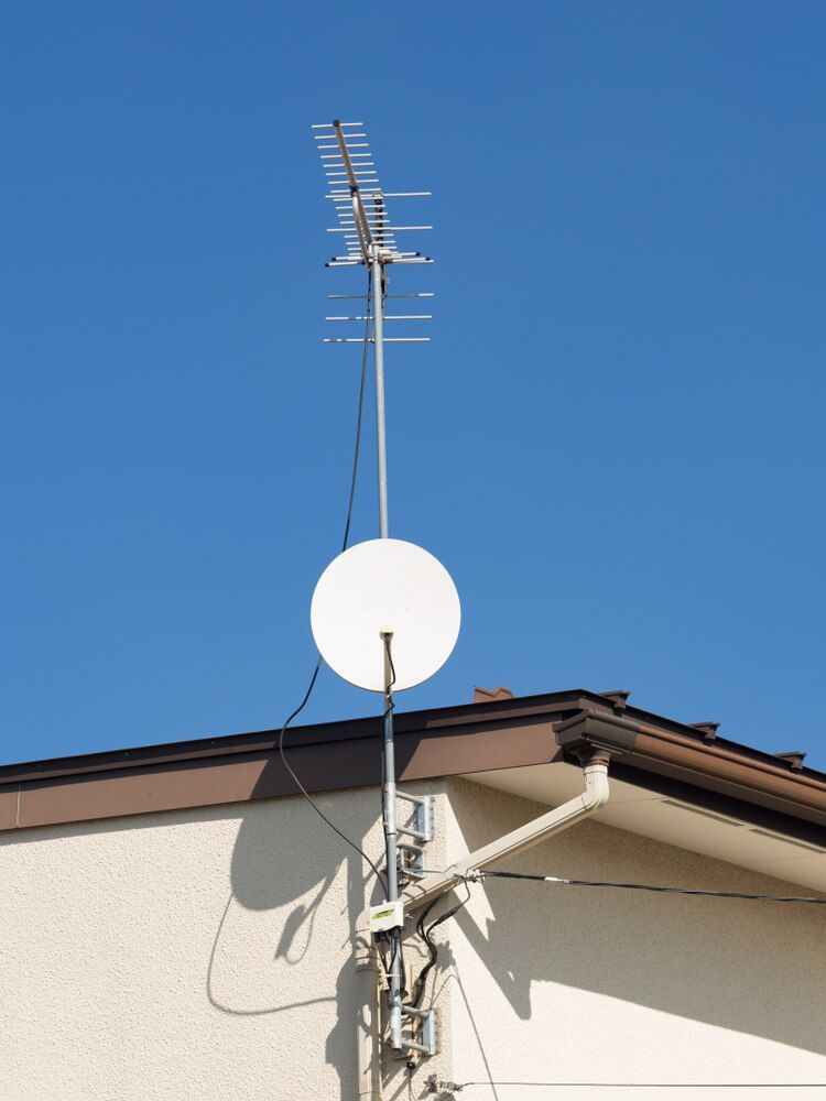 A Satellite Dish Is Attached to The Side of A Building — BTV Antenna & Data in Bargara, QLD
