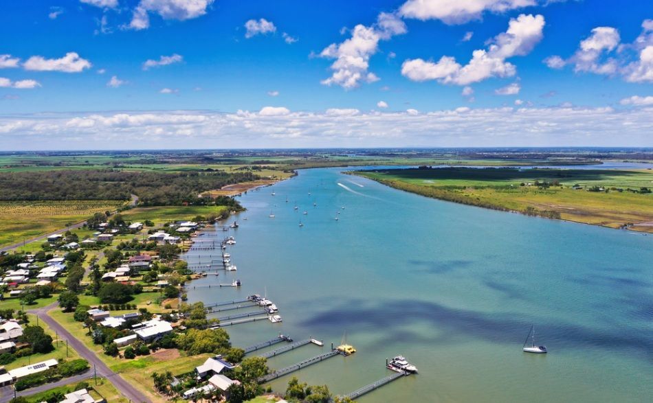 An Aerial View of A Large Body of Water Surrounded by Houses and Trees — BTV Antenna & Data in Bundaberg, QLD