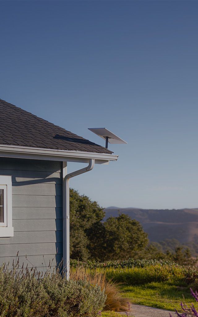A Satellite Dish Is Attached to The Side of A Brick Building — BTV Antenna & Data in Coral Cove, QLD