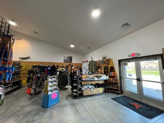 The inside of a store with a lot of clothes on display.