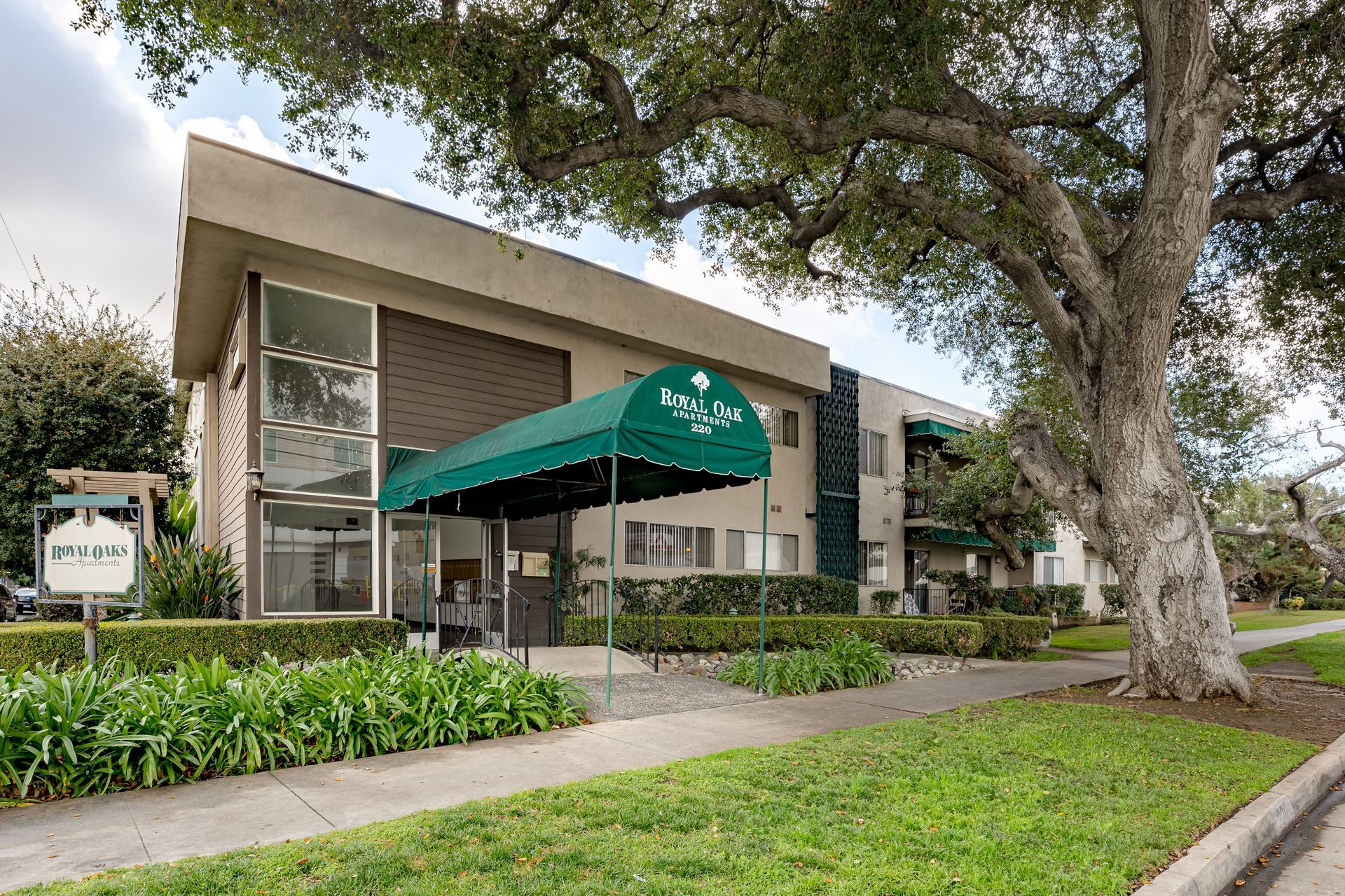 A large building with a green awning over the entrance.