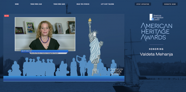 a computer screenshot of a woman is sitting in front of a screen that says american heritage awards .