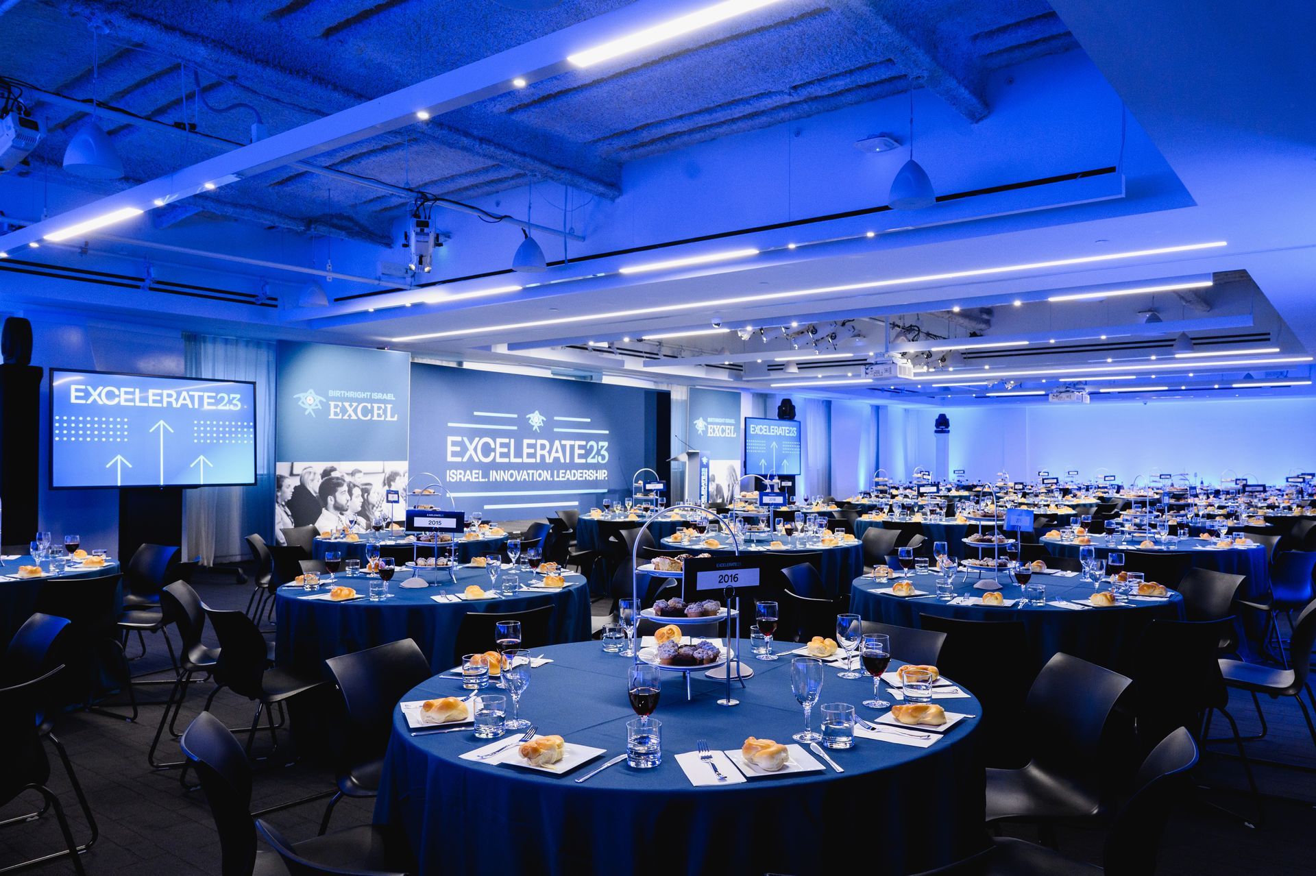 a large room with tables and chairs set up for the general assembly.