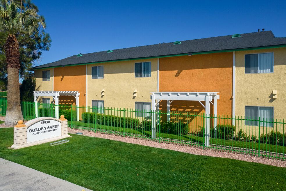 A large apartment building with a sign in front of it