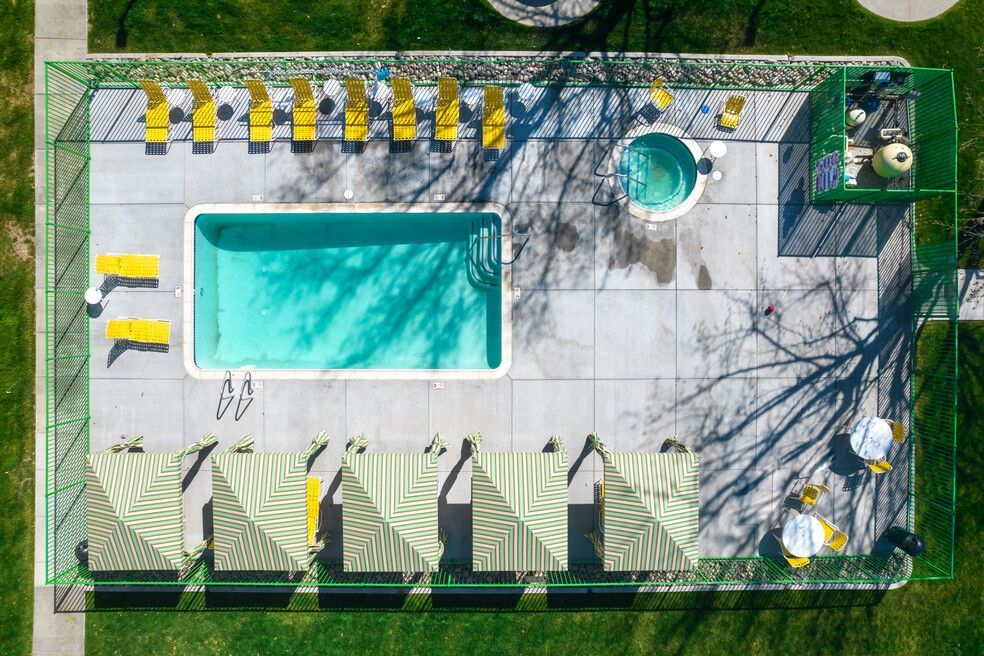 An aerial view of a swimming pool in a park.