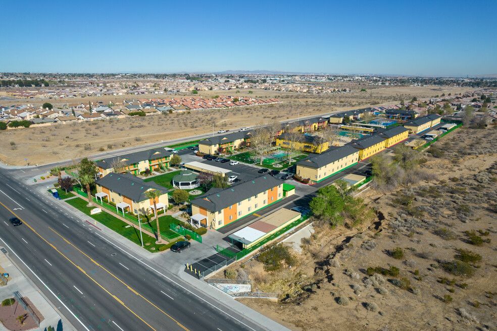 An aerial view of a residential area next to a highway.